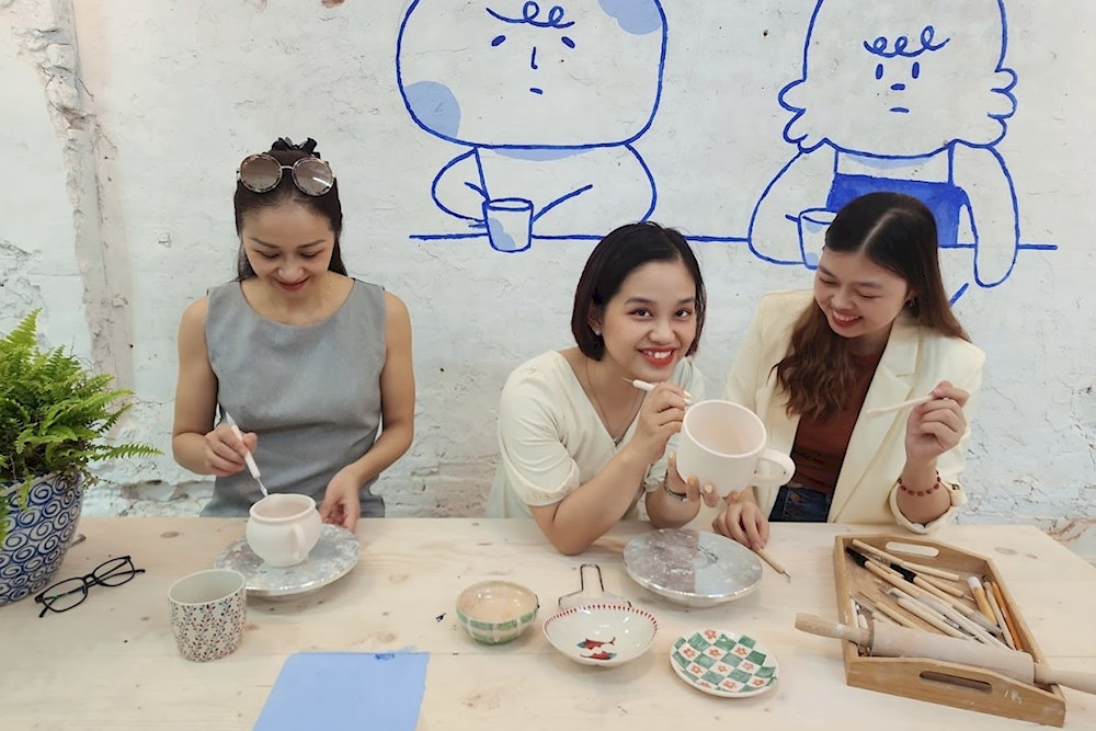 Tourists immerse themselves in a hands-on pottery-making experience in Hanoi